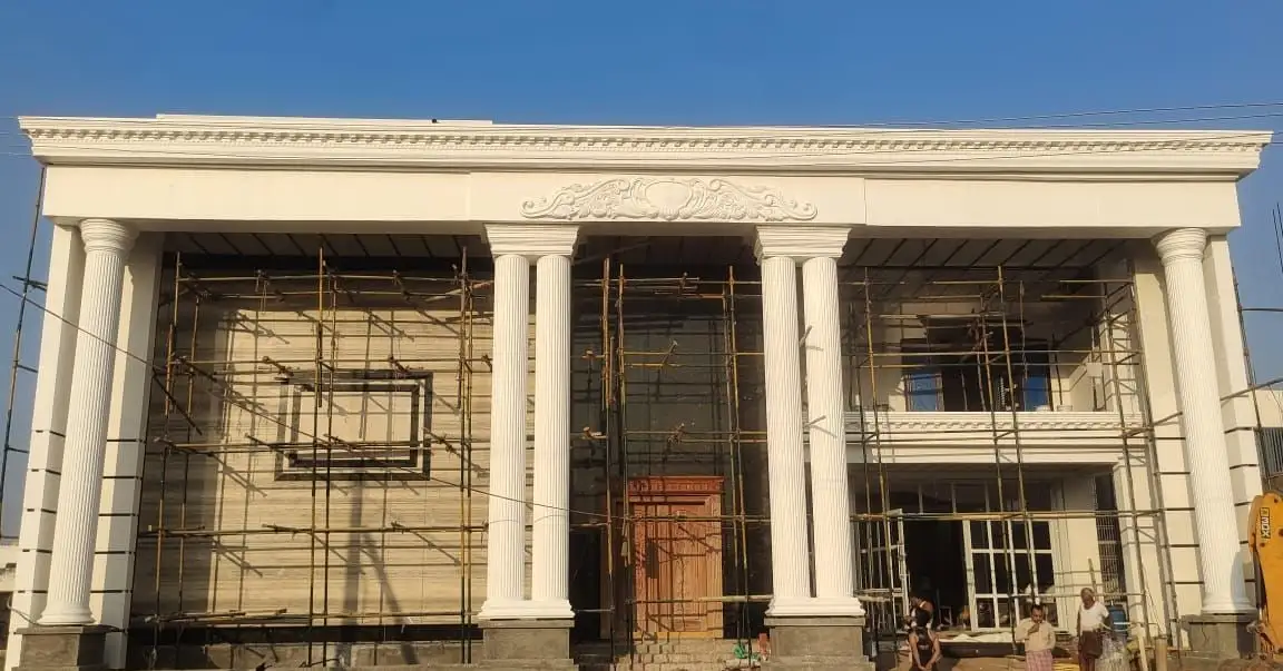 Saree manufacturer's office, Dharmavaram, Andhra Pradesh: Paired fluted columns, the dentil cornice and the central cartouche, with scaffolding still up